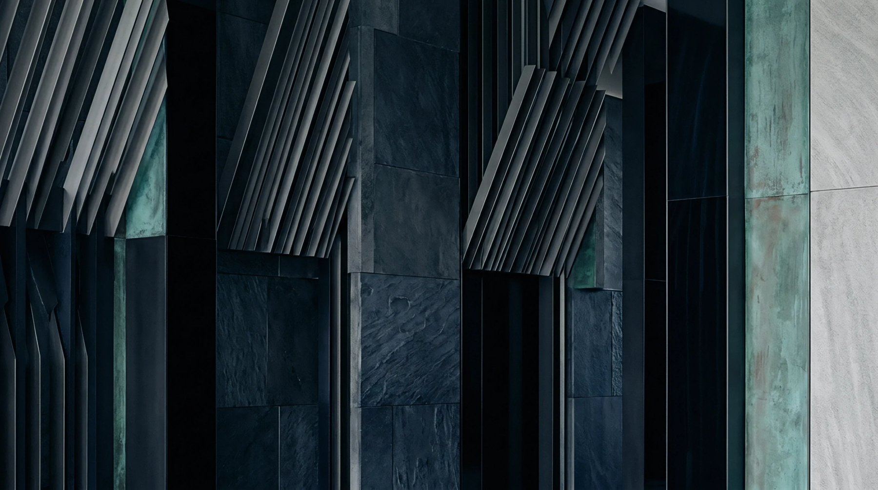 Layered vertical stone tiles and angled industrial metal louvers comprise structural wall assemblies built from raw mineral and fabricated metal components.